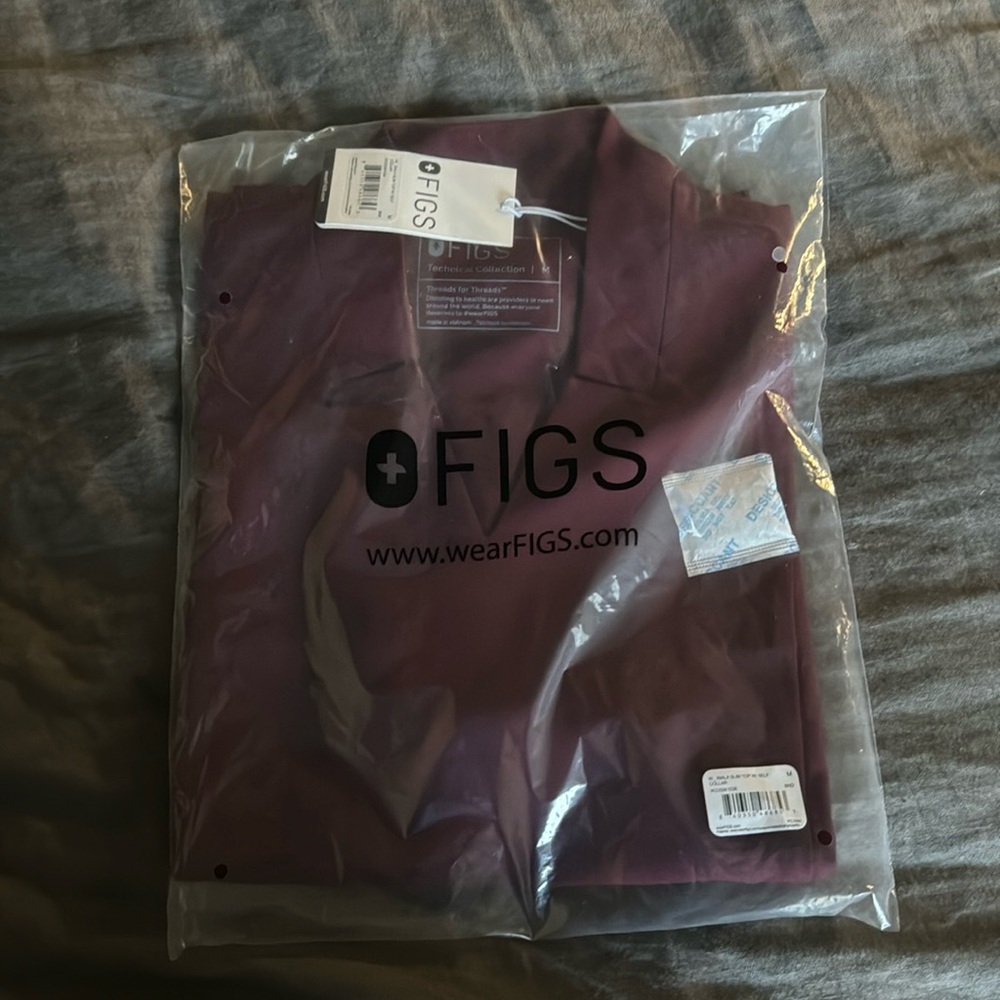 NWT and  in original package. Inla FIGS scrub top size medium. Burgundy color